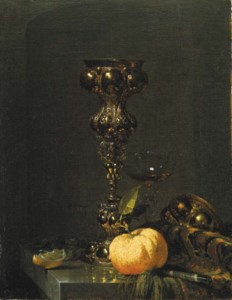 A steeple cup with upturned cover, a glass of wine, an orange and a knife on an Oriental rug on a draped marble ledge
