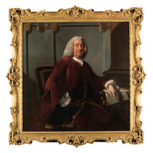 Portrait of a Joseph Gulston (1694-1766), three-quarter-length, seated, in a brown coat and blue waistcoat with gold trim, his left arm resting on a table, in an interior