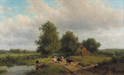 Cows on a sandy track in a wooded landscape
