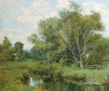 A sunlit landscape with a pond
