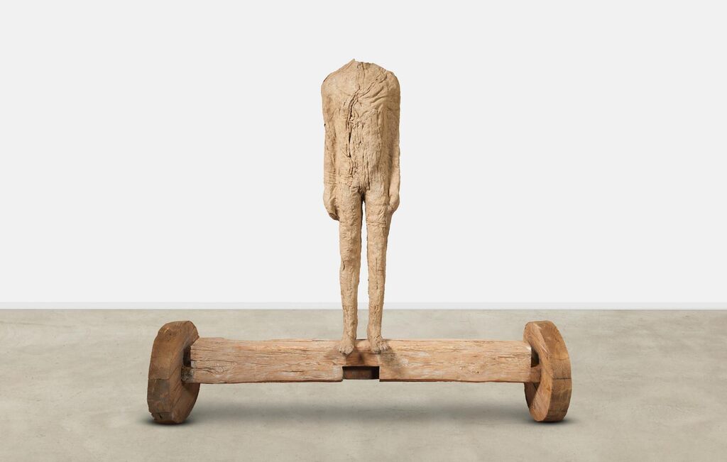 Figure on Beam with Wheels