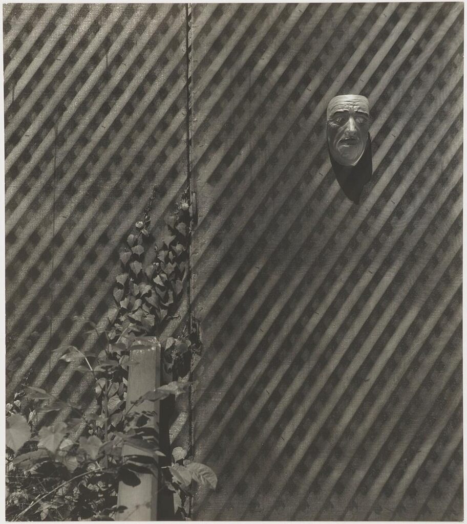 Untitled (Mask Hanging on Fence)