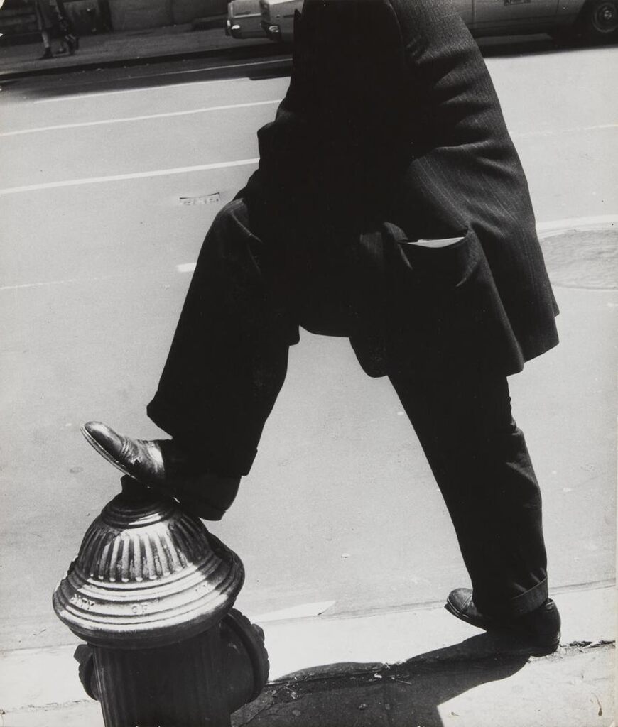 NYC [man resting his foot on a fire hydrant]