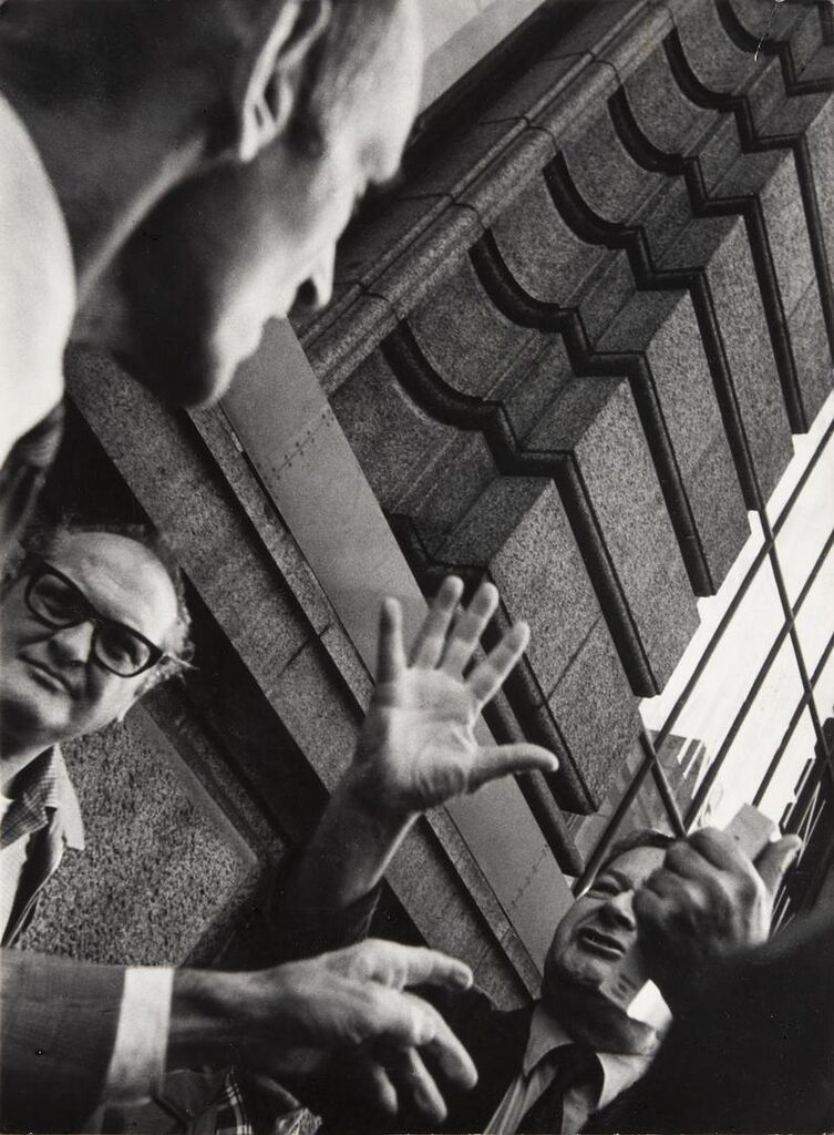 Untitled, New York [street scene, men with hands raised]