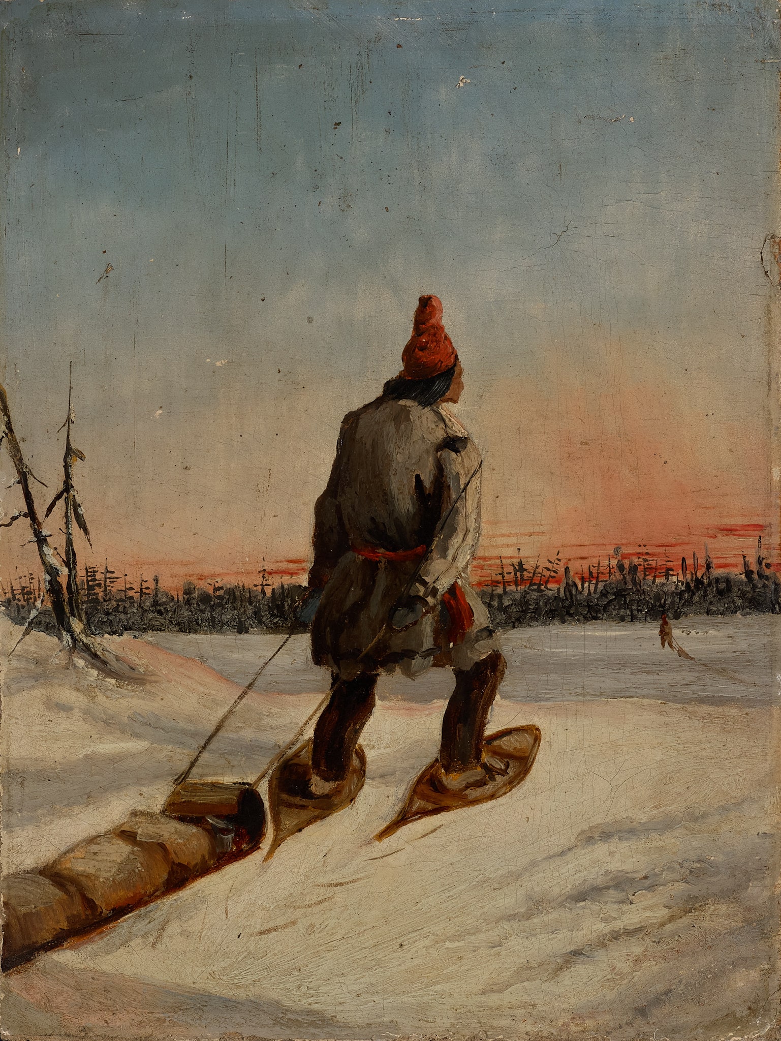 Man on Snowshoes pulling Toboggan