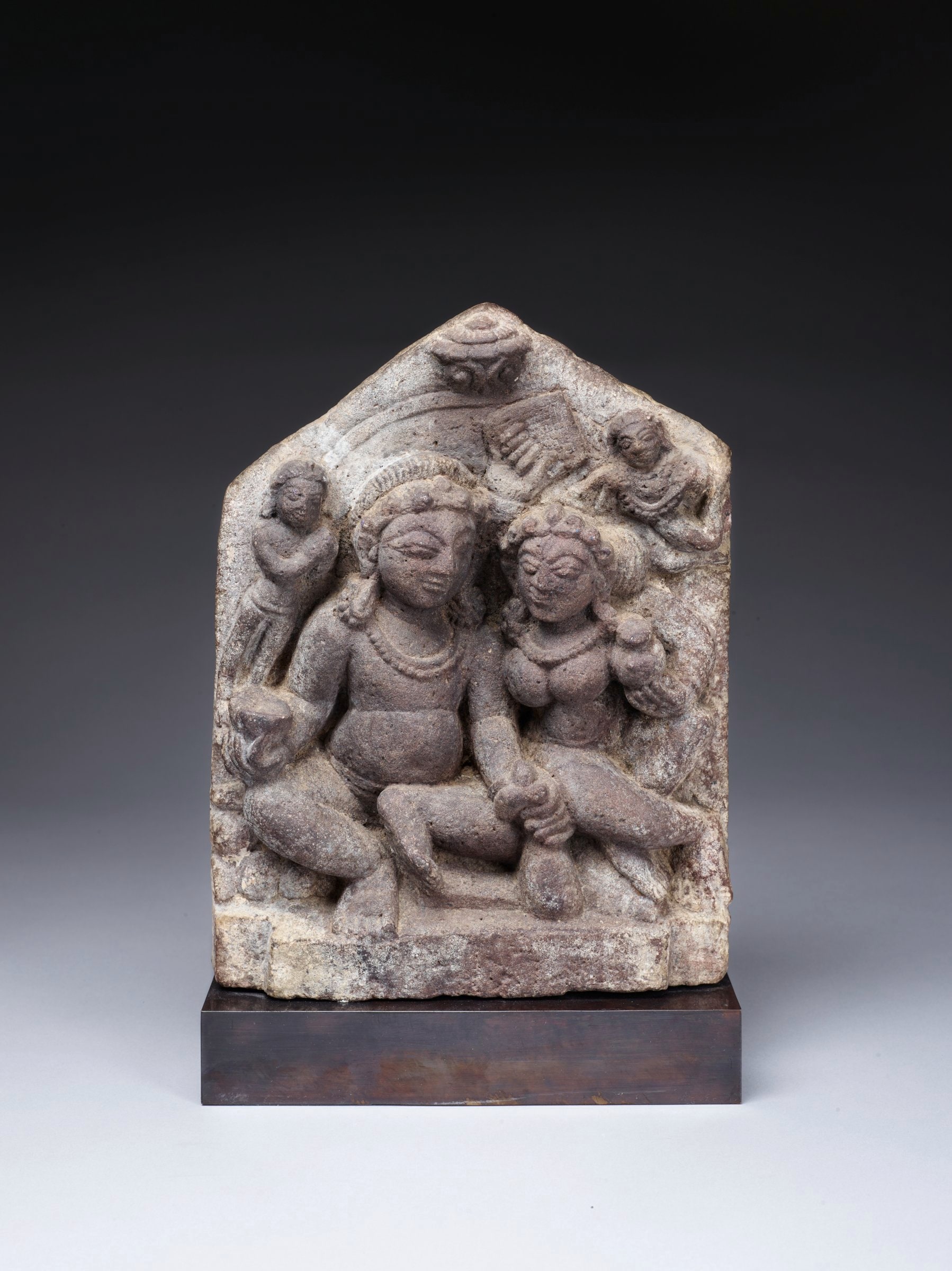 Seated Divine Loving Couple with Flying Garland-Bearer and Attendant Revered in Animism, Buddhism, Hinduism, Jainism, and Sikhism
