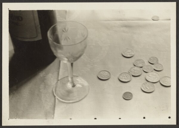[Still life with glass and coins]