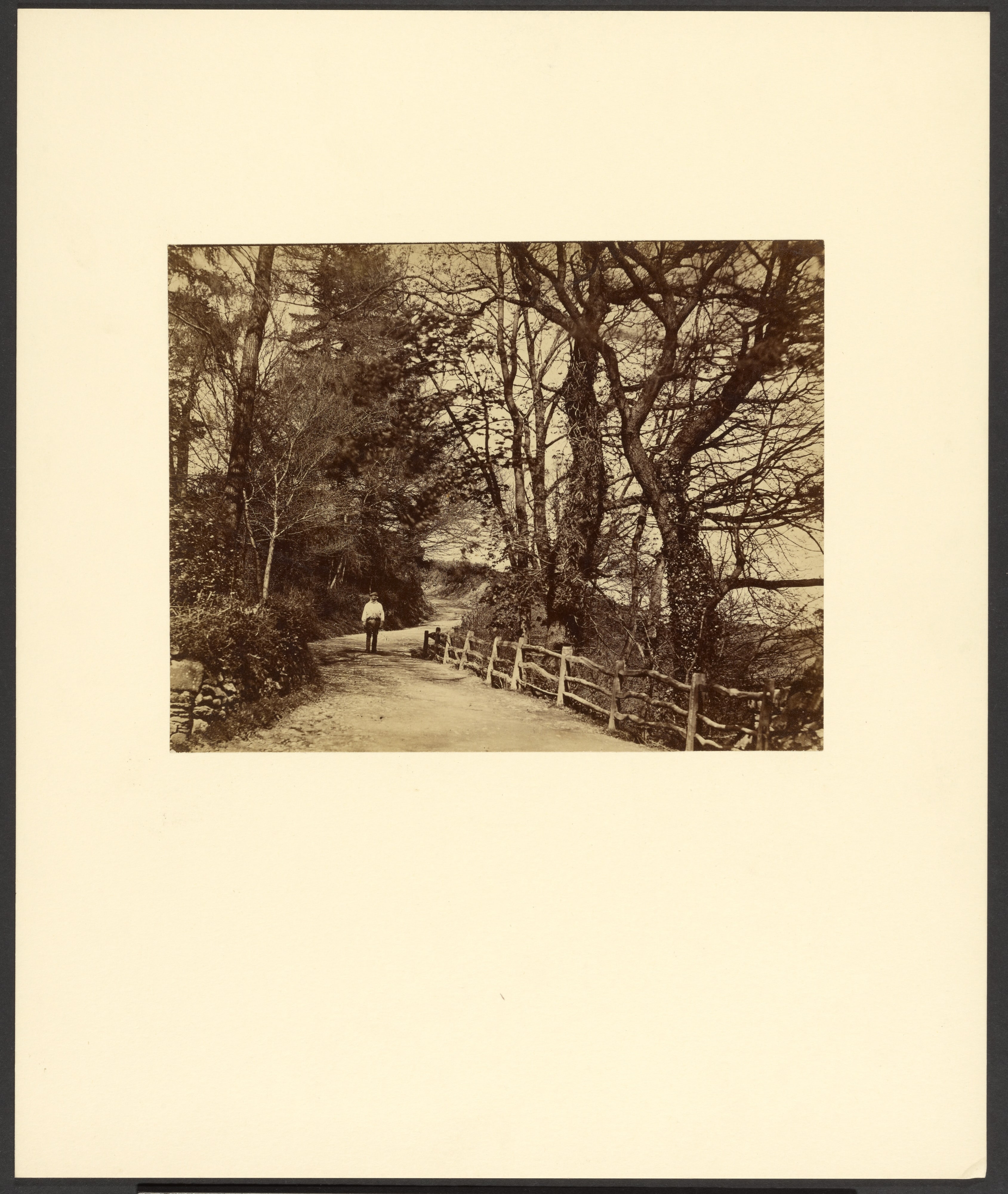 [Man standing on dirt road]
