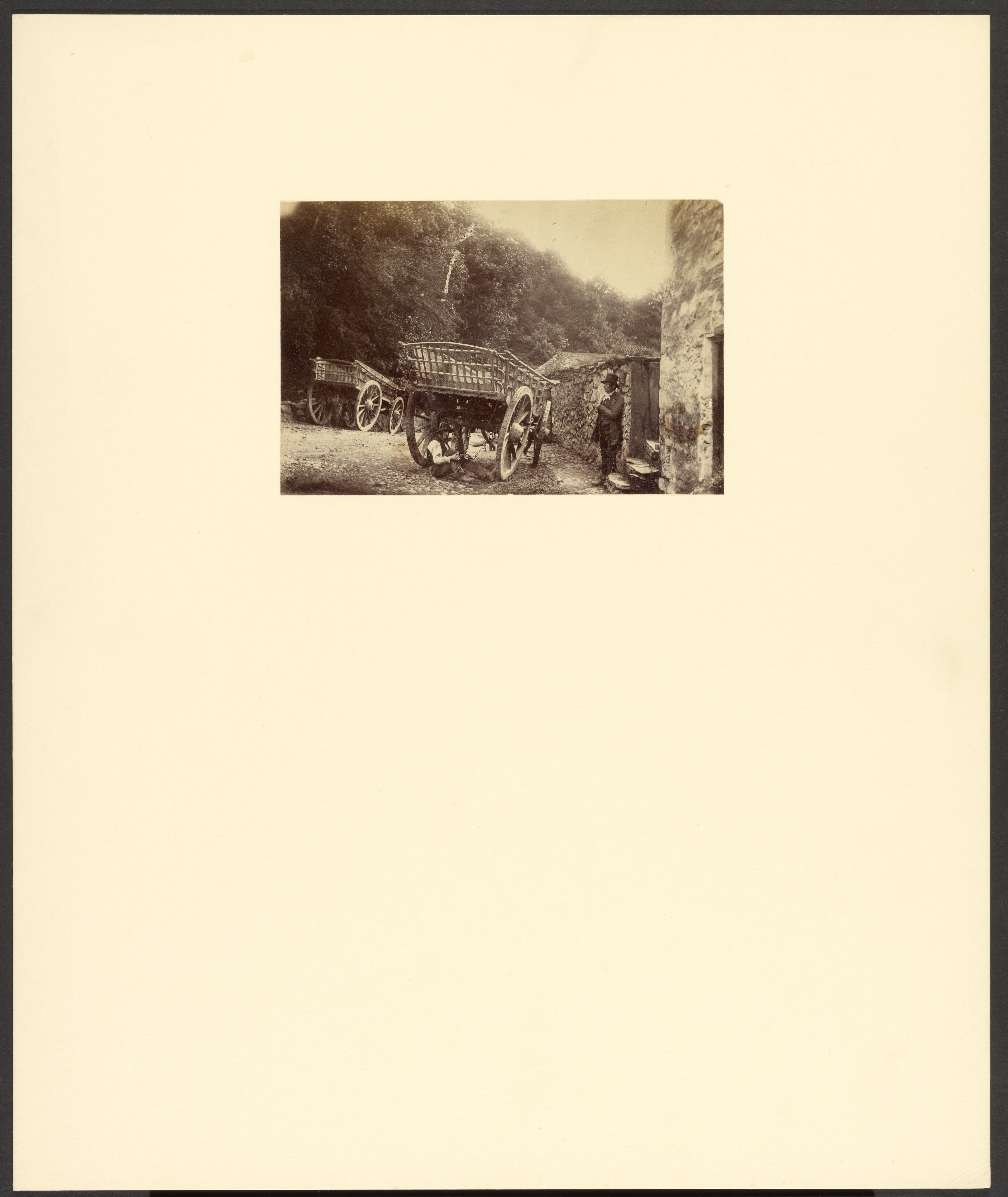 [Two men with cart]