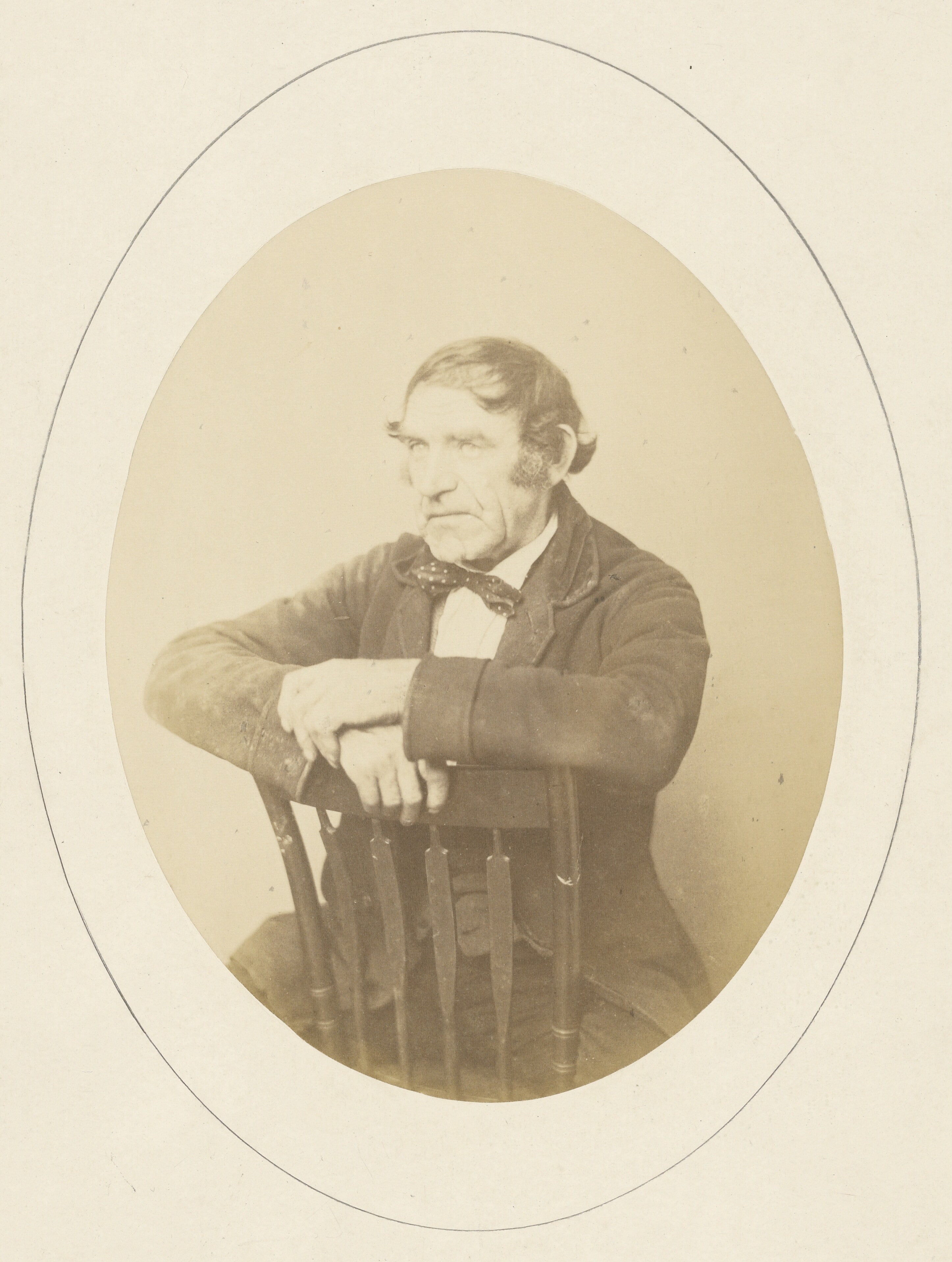 [Portrait of man seated on chair]