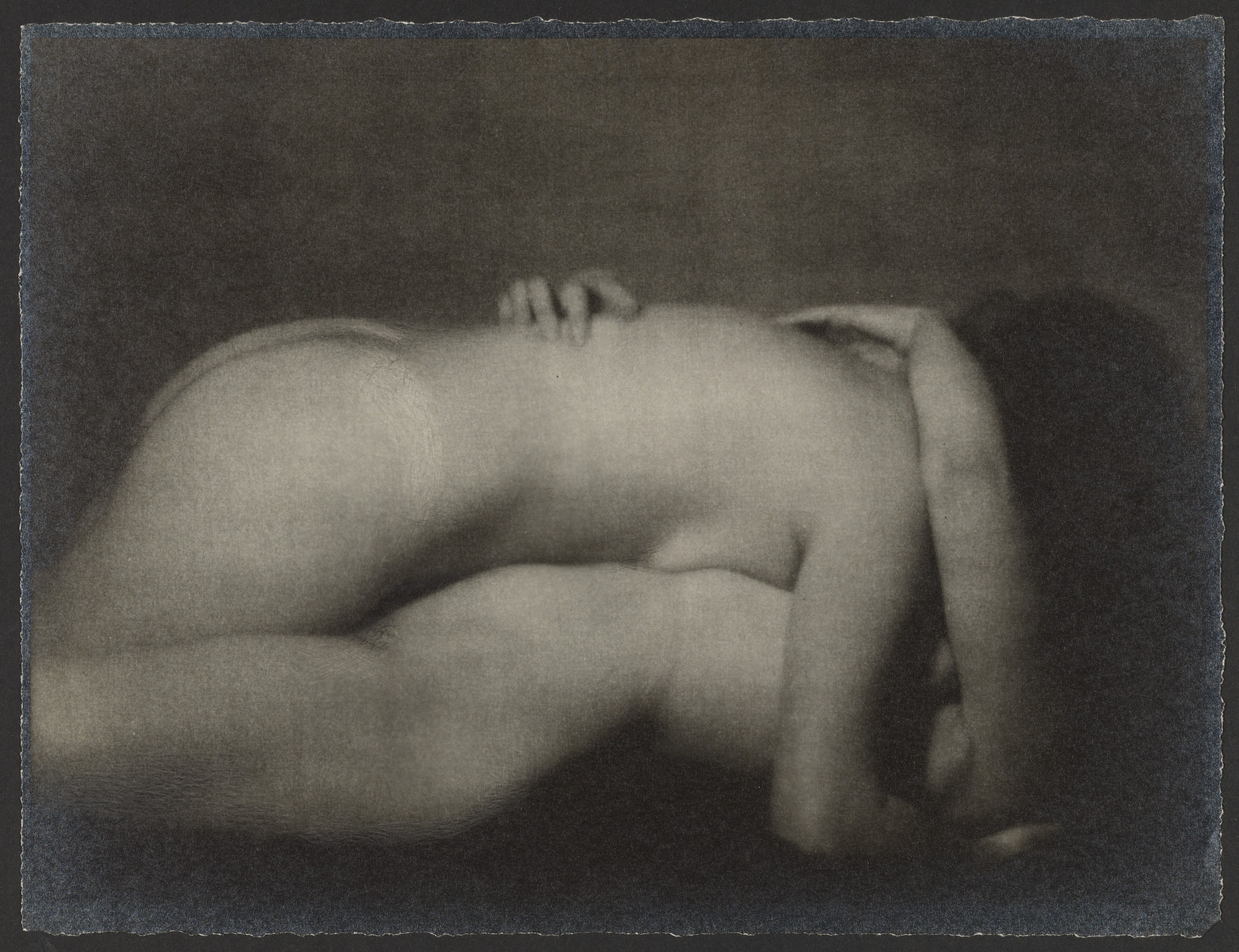 [Two nude women embracing]