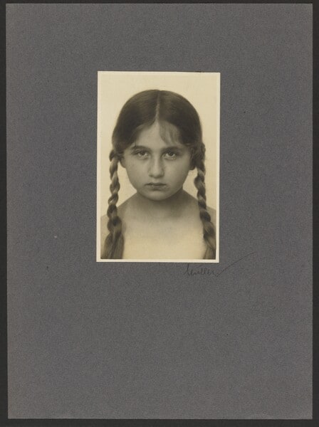 [Portrait of young girl with braids]