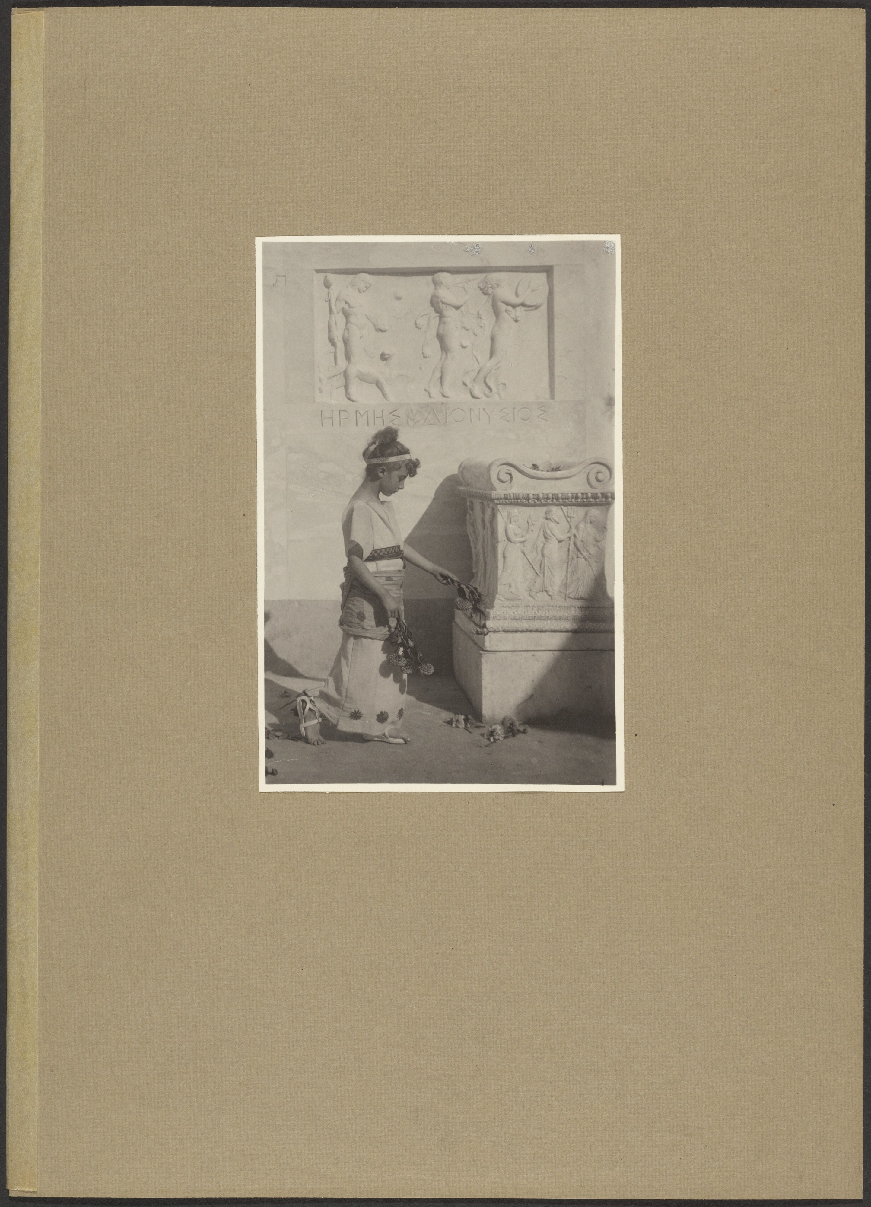 [Young Girl Dressed in Greek Costume Tossing Flowers at the Base of a Pedestal]