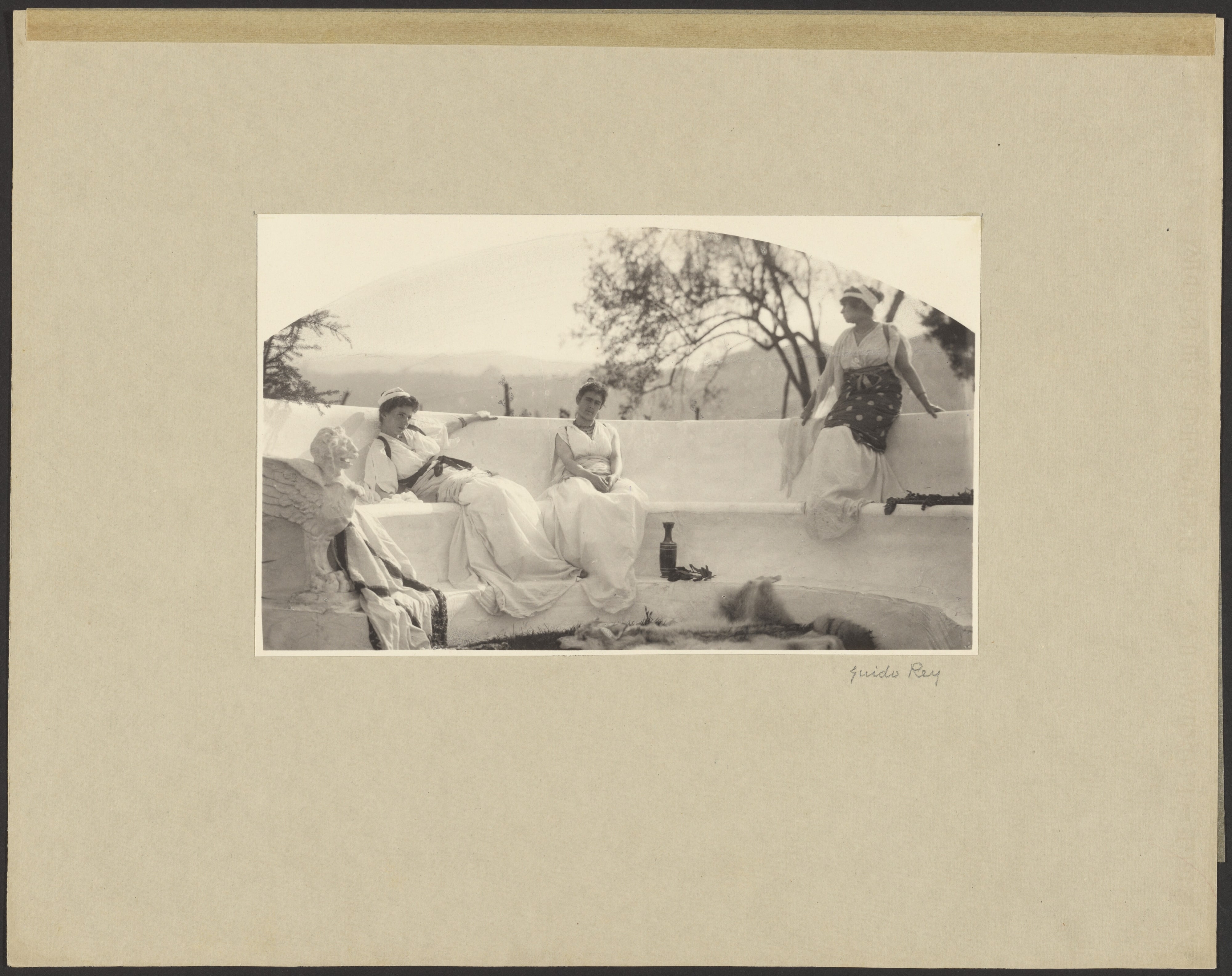 [Three Women in Classical Robes Posed Outdoors on a Concrete Terrace]