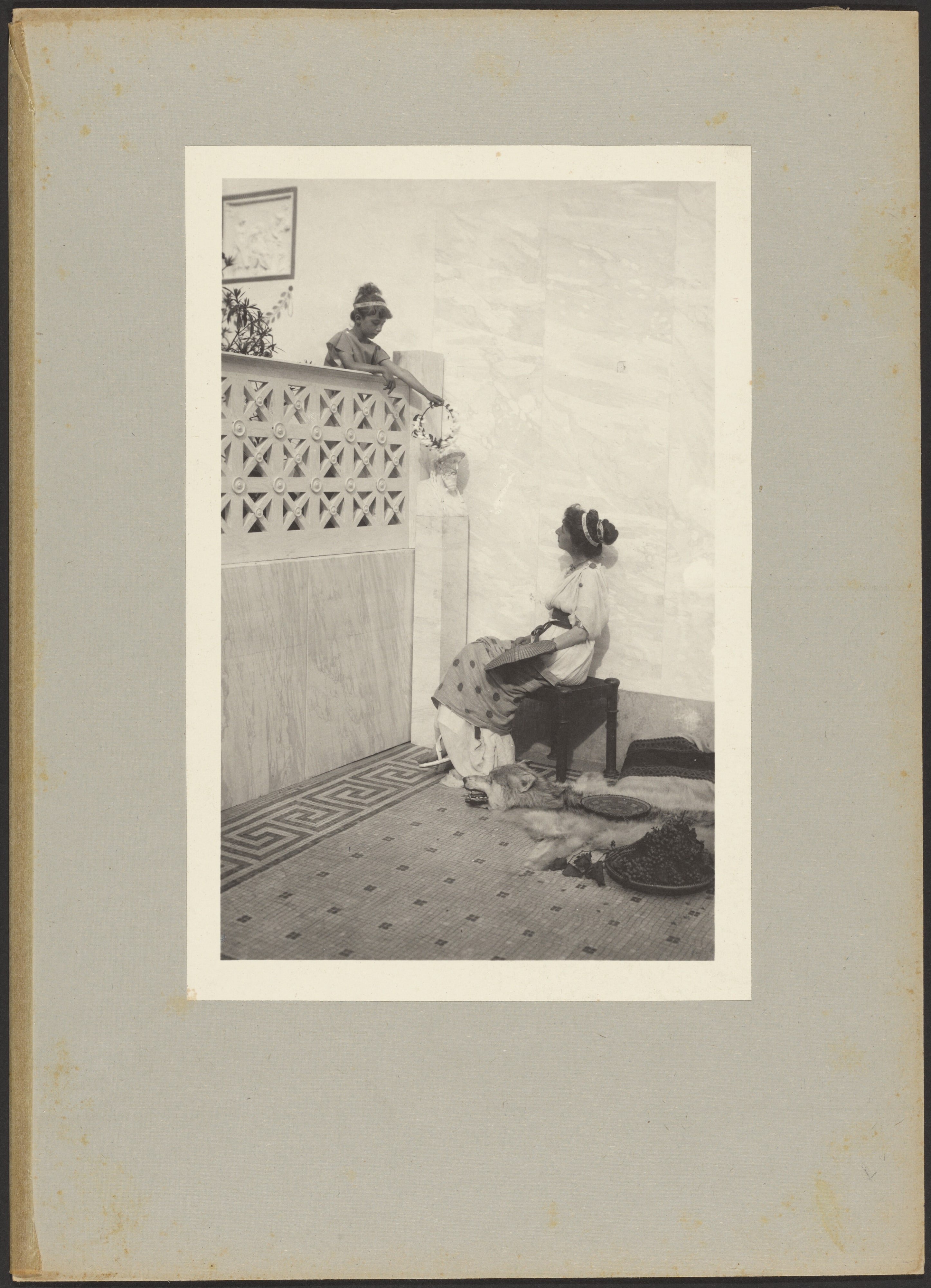 [Young Boy on Balcony Offering a Flower Head Wreath to a Seated Woman Holding a Fan]