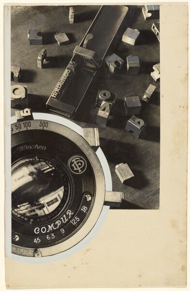 "Monatsschrift" [Advertising Photograph with Camera Lens & Typesetting Equipment]