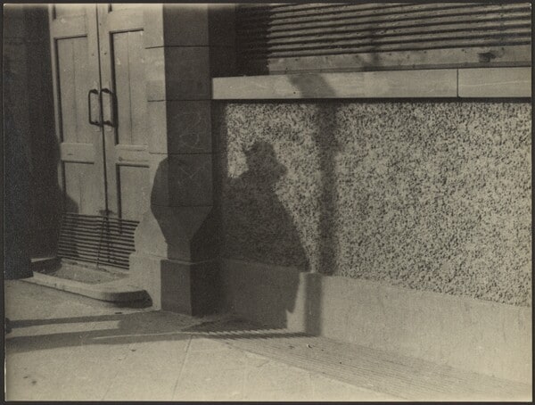 [Man's Shadow on Stucco Wall]