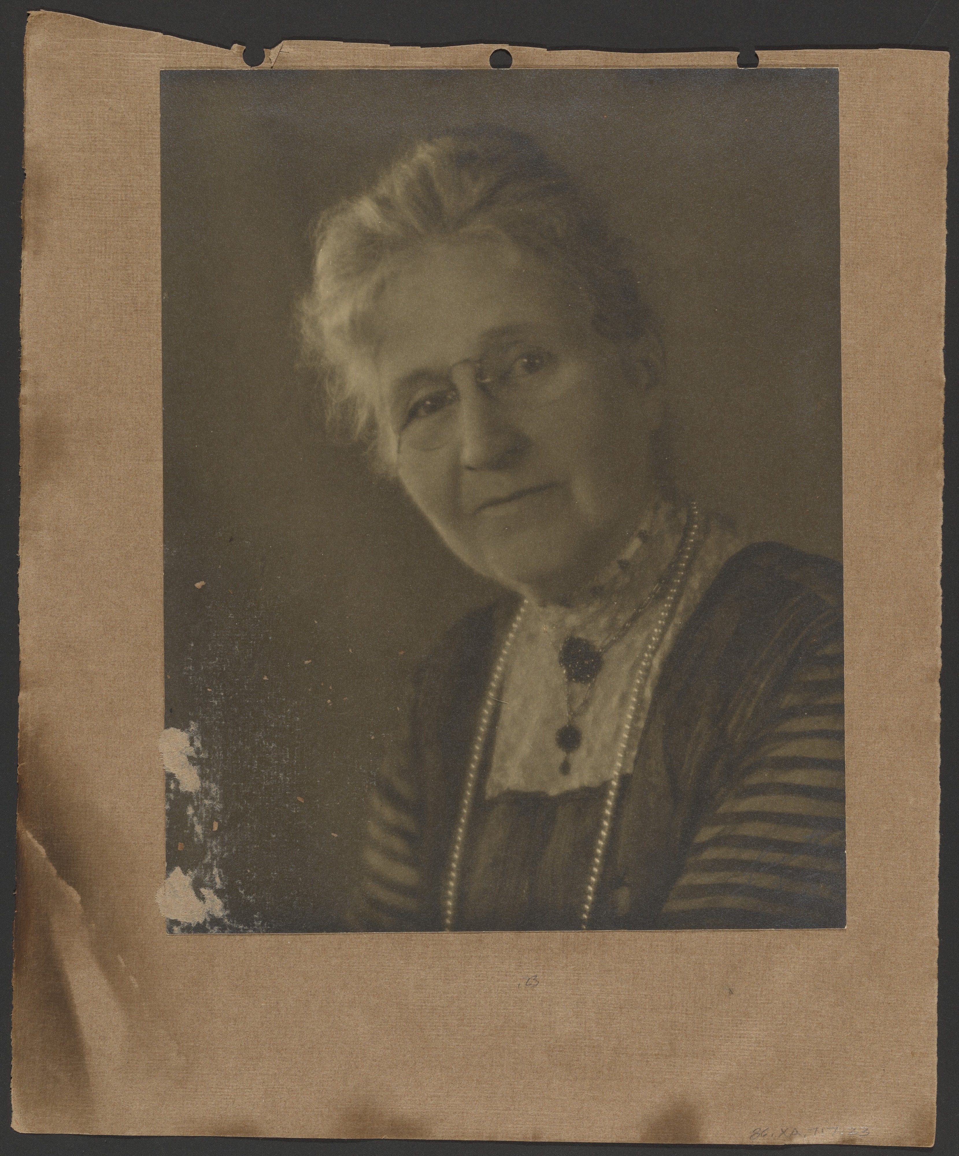 [Elderly woman wearing glasses]