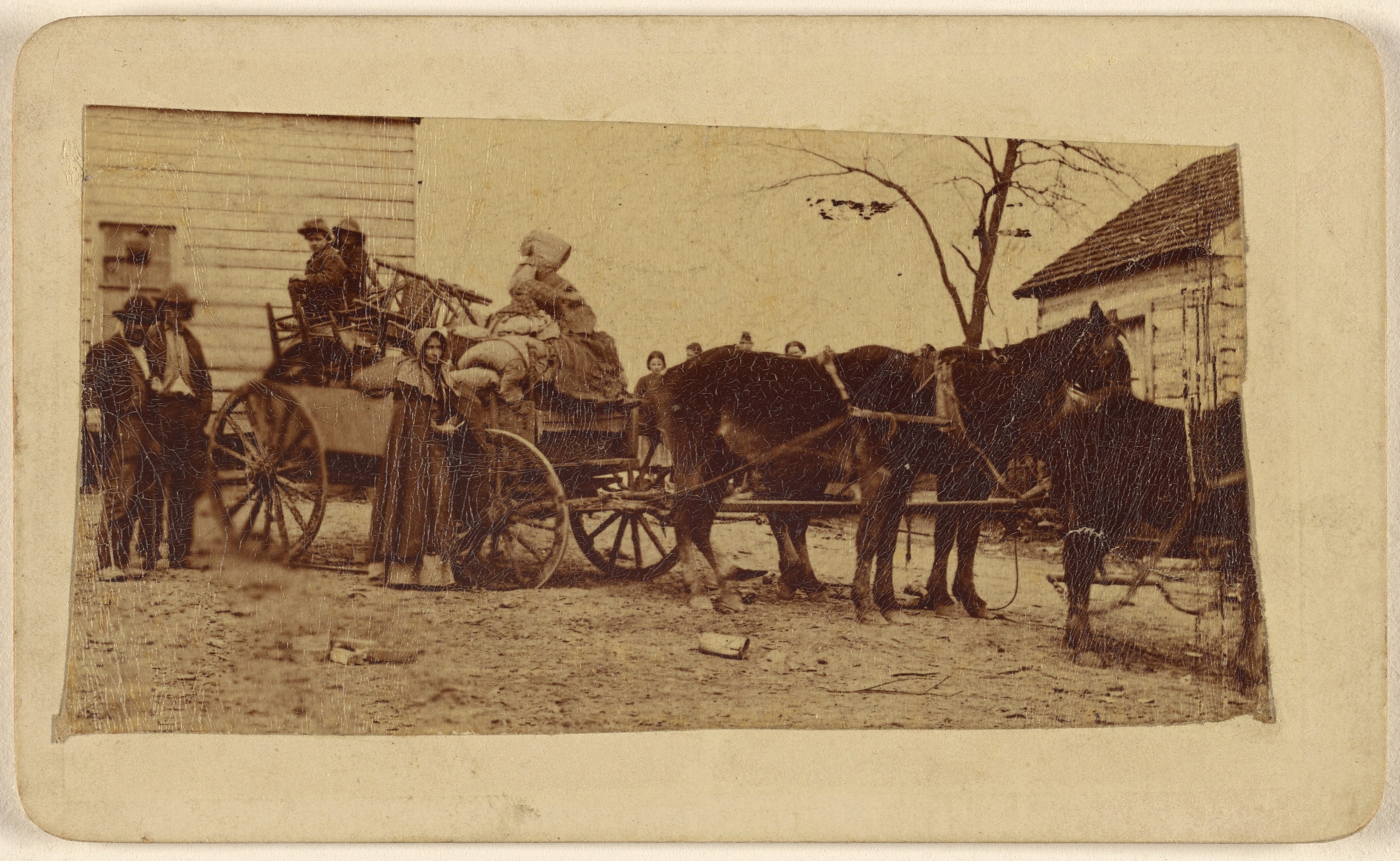 [Family on a horse-drawn wagon]