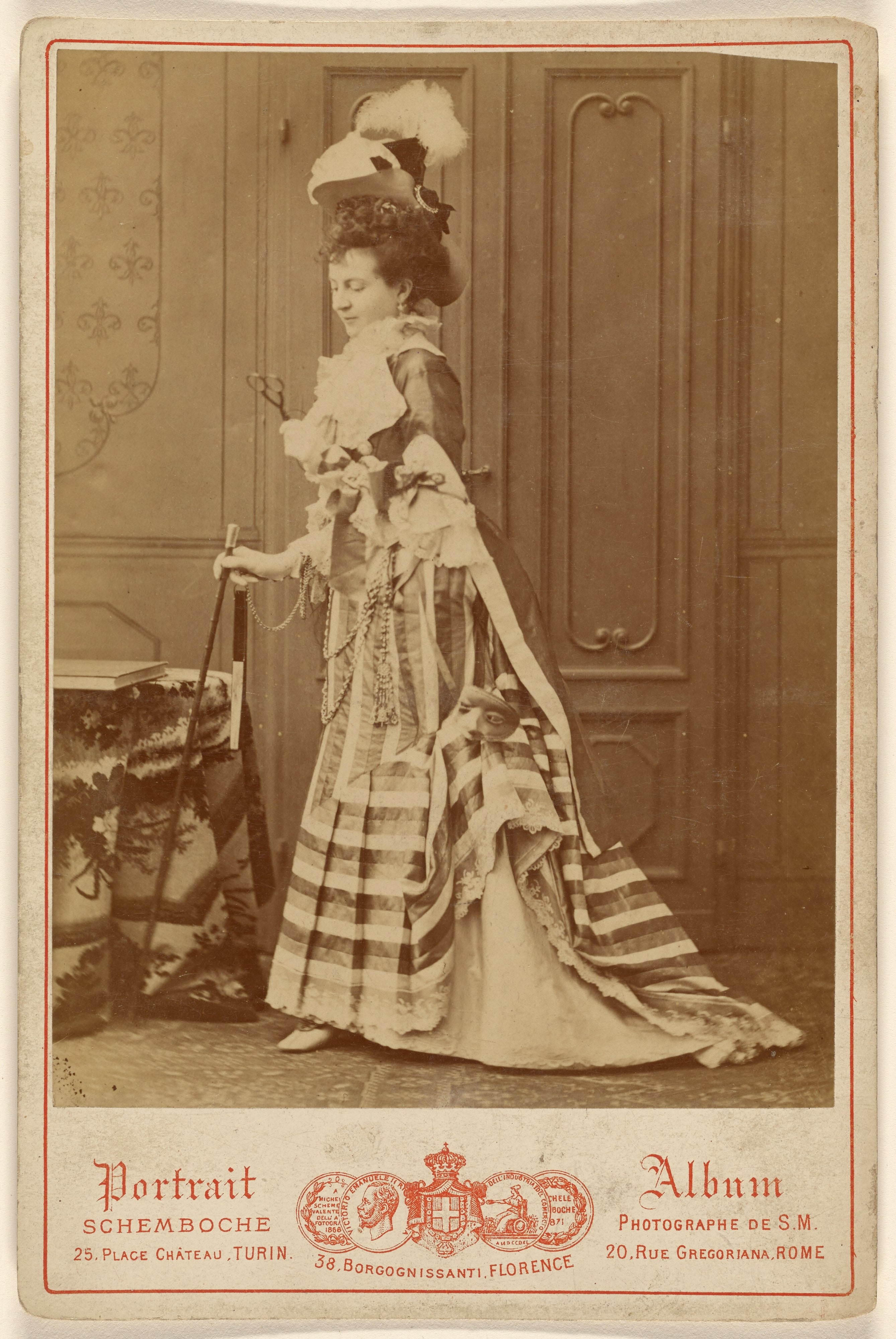 [Full-length portrait of a well-dressed woman with walking stick]