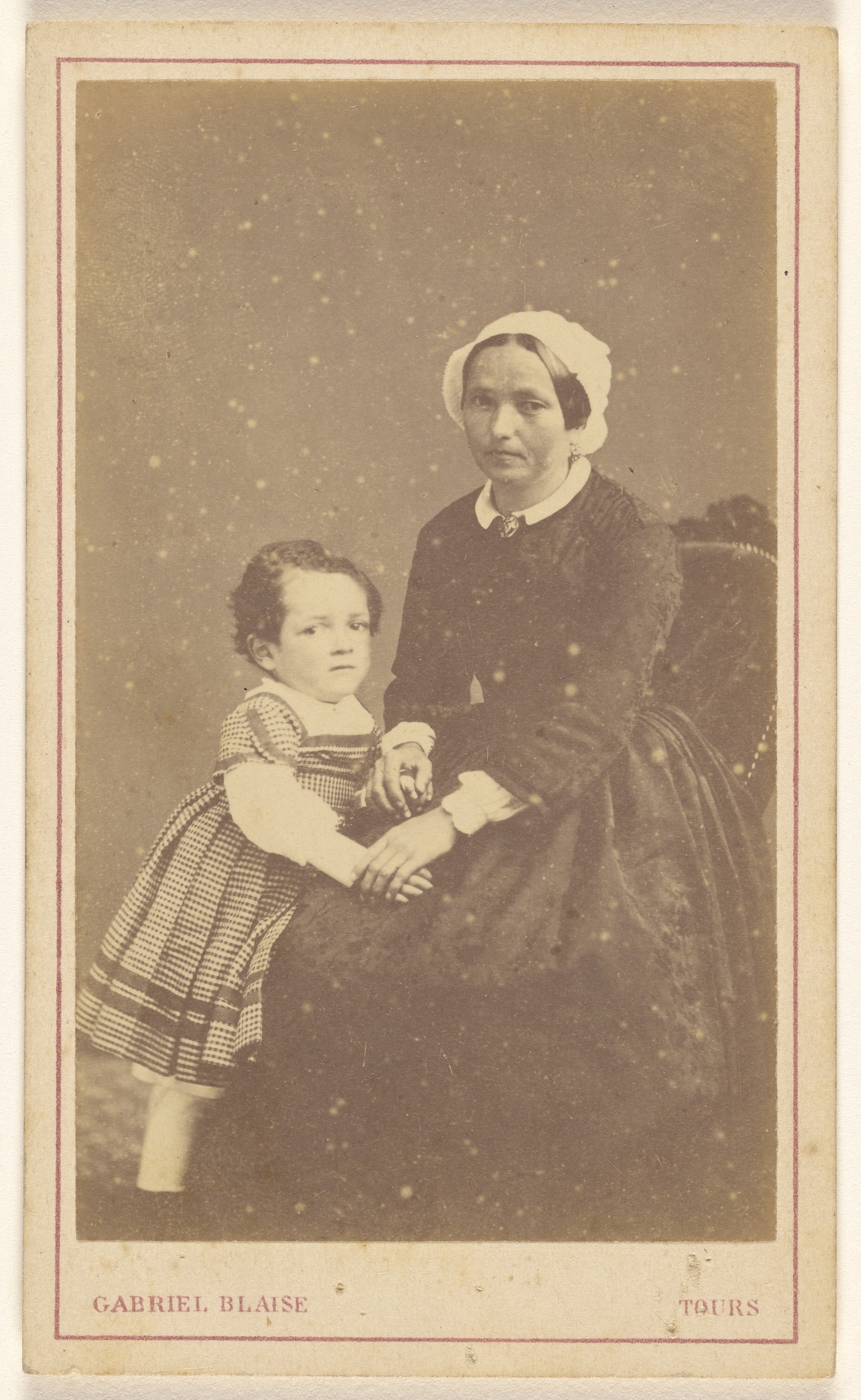 [Unidentified woman seated, with a little girl standing next to her]