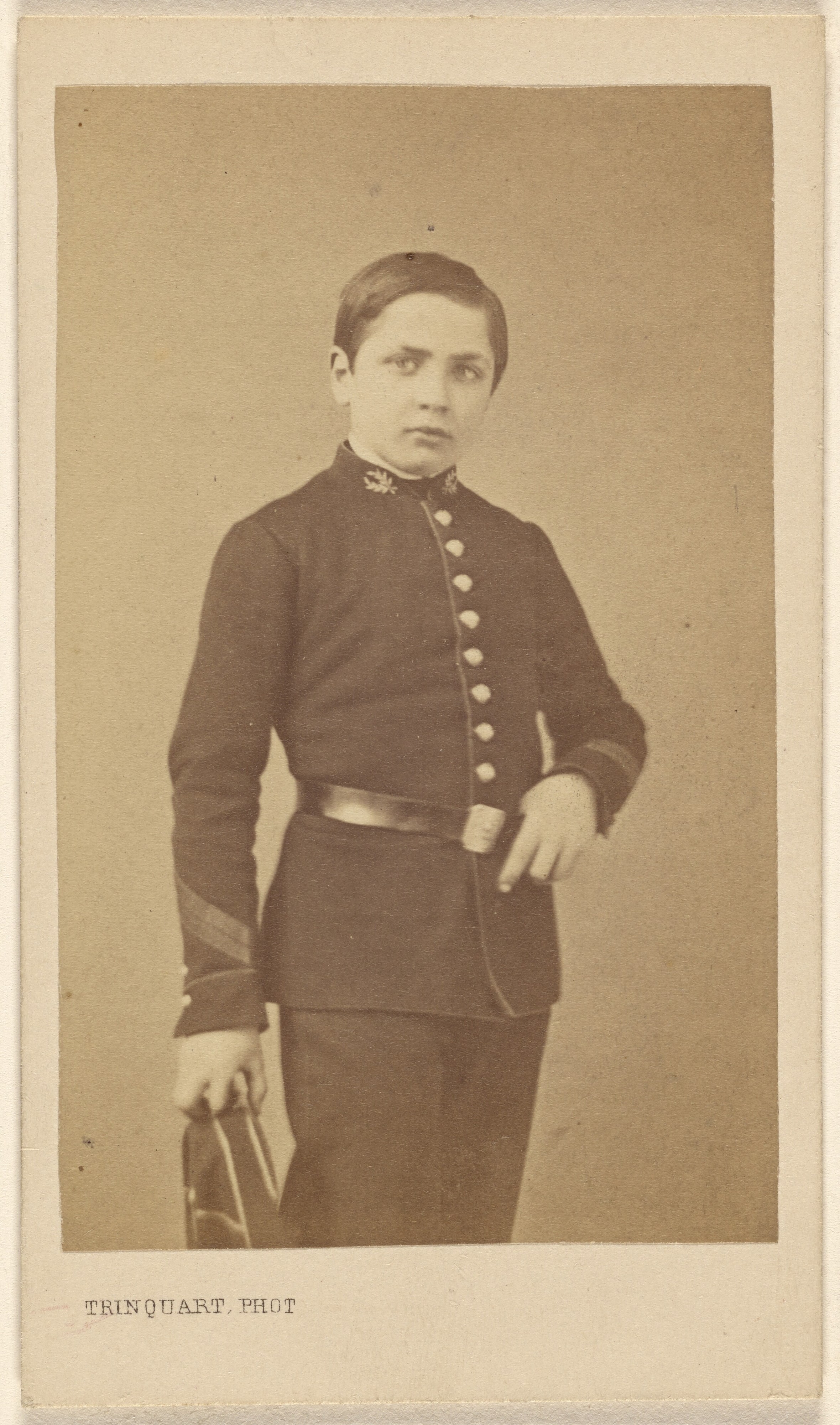 [Unidentified young boy in uniform, standing]