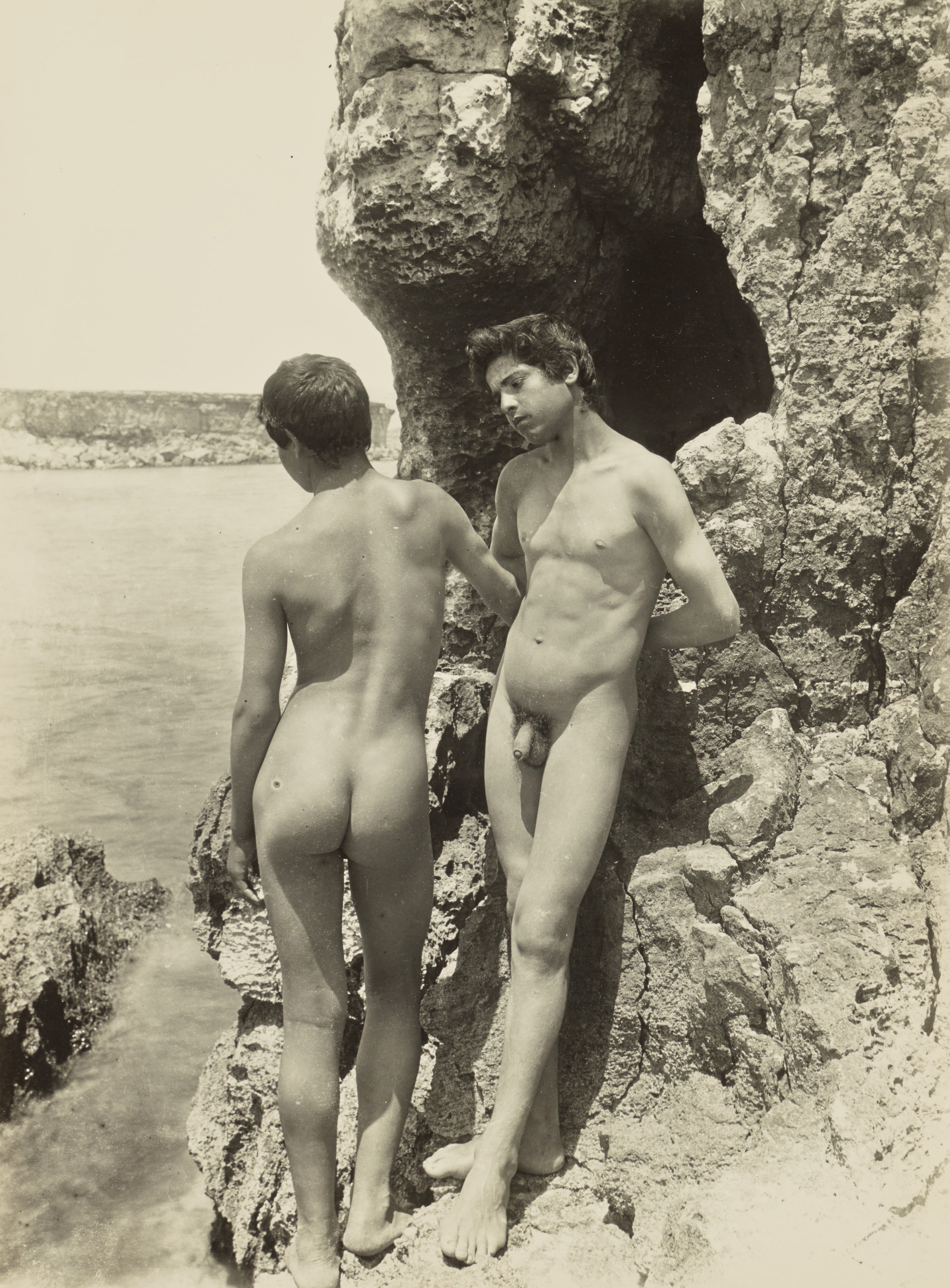 [Two nude youths by the sea]