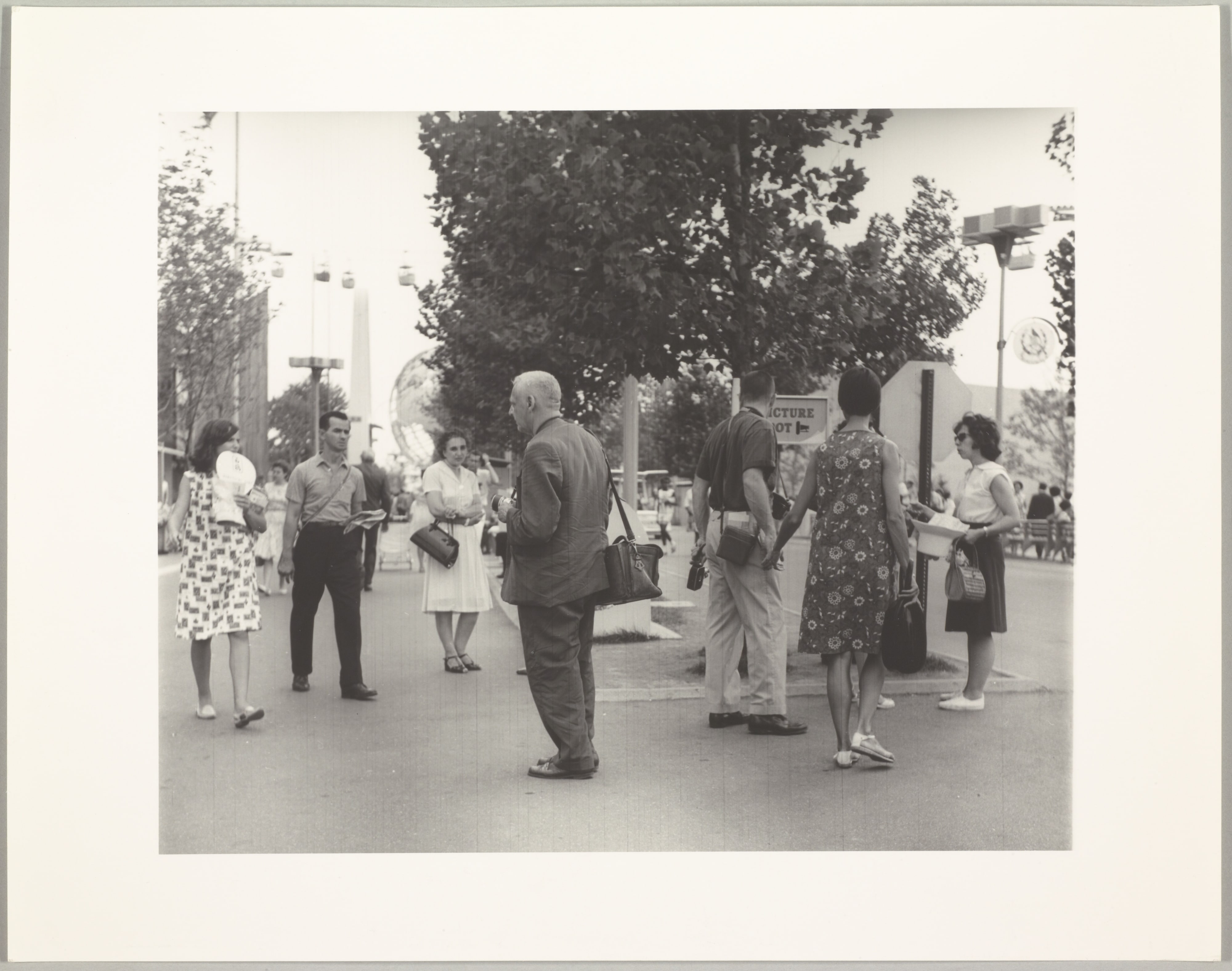 Weegee at World's Fair Looking at Pretty Girl