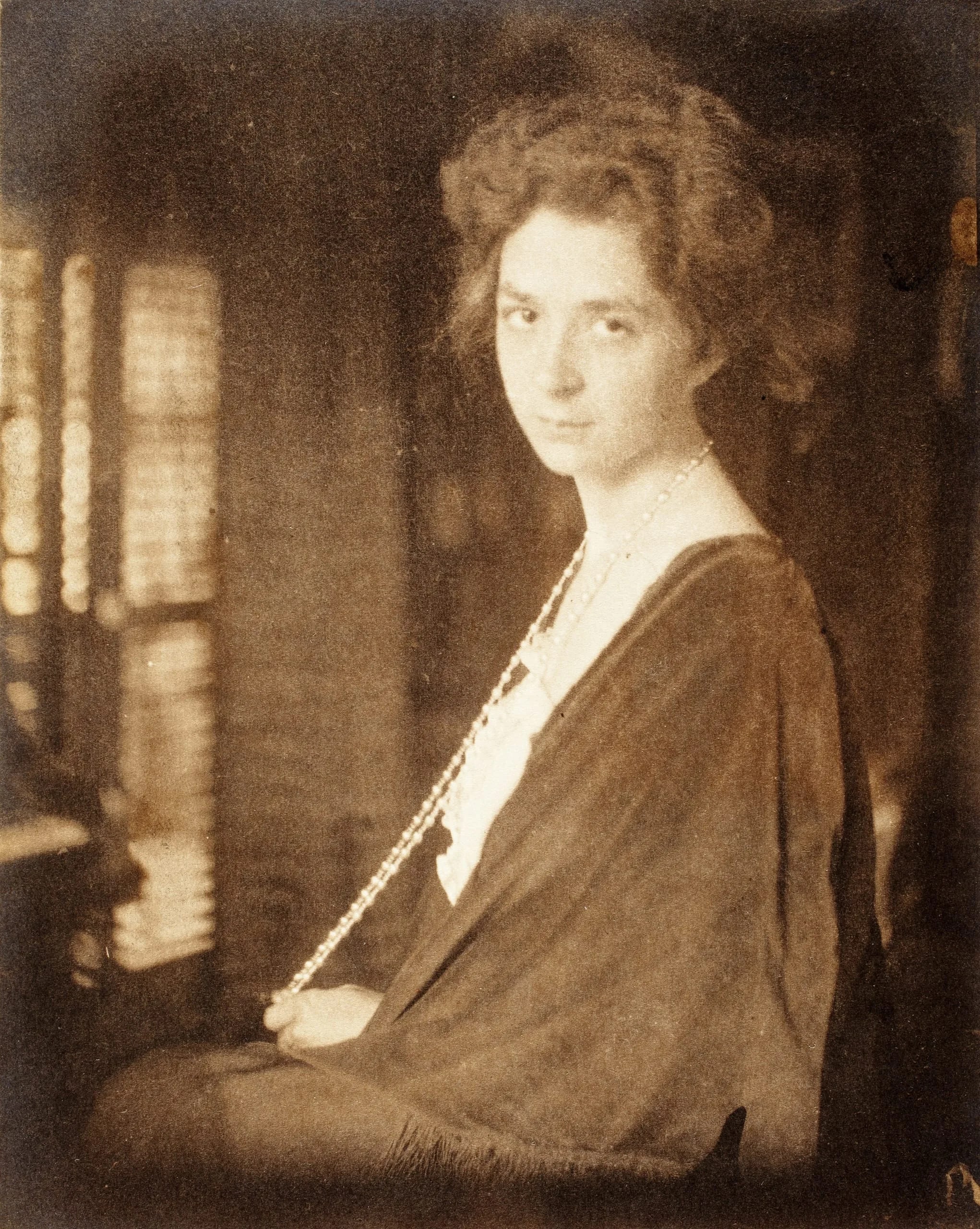 Woman With Long Pearl Necklace