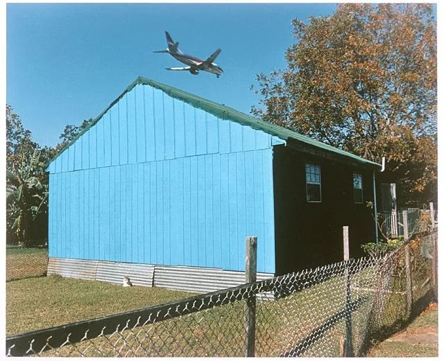 Jet Over Blue and Black House