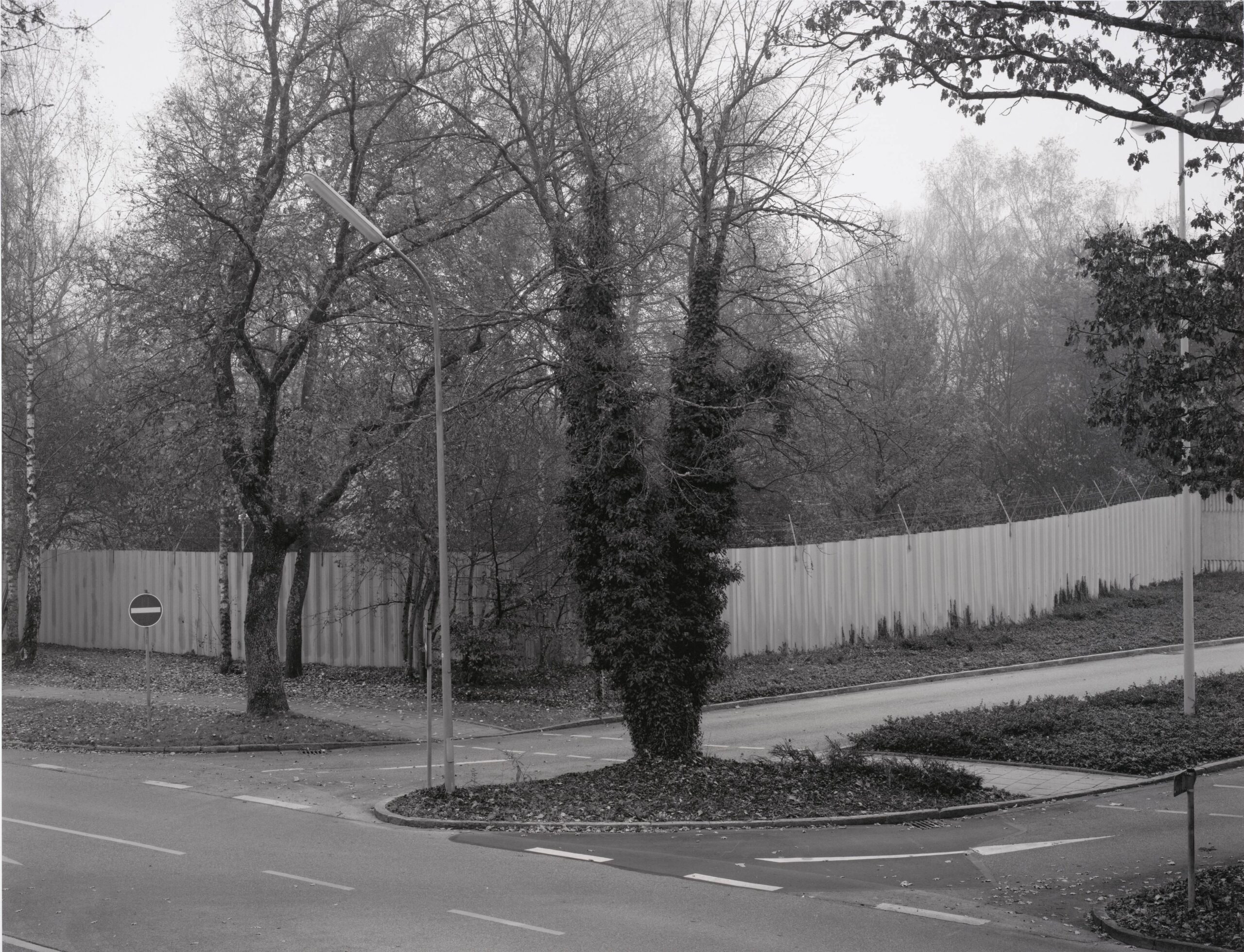 Linker Teil der Haupteinfahrt, im Hintergrund Parkplatz auf dem so genannten Bunker Hagen (Left Side of the Main Entrance; in the Background is the Parking Area of the So-Called "Hagen" Bunker)