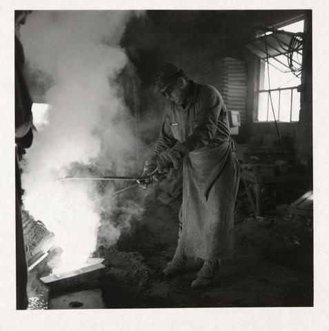 Untitled (foundryman pouring molds)
