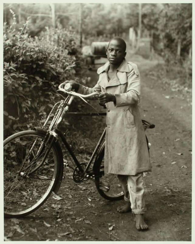 Young Man with Bicycle along Road