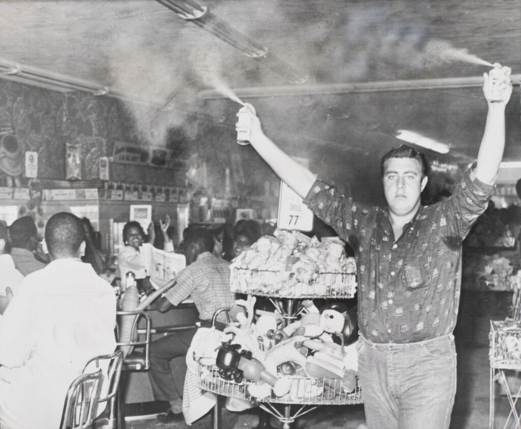 Man Spraying Deodorant over Heads of Sit-in Demonstrators at Woolworth’s, Atlanta