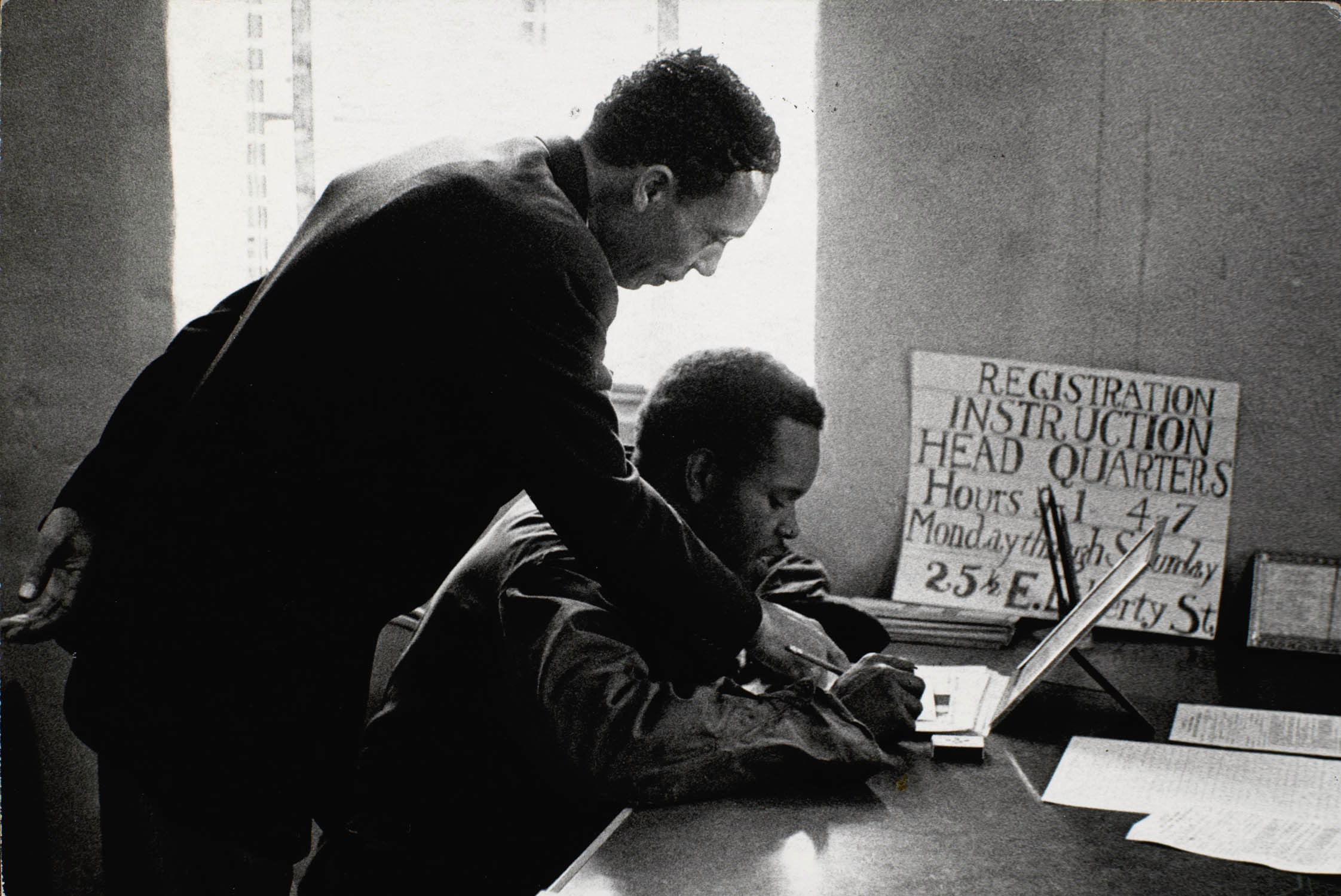 Frank Robinson Assists a Prospective Voter Fill Out Registration Form, Sumter, South Carolina