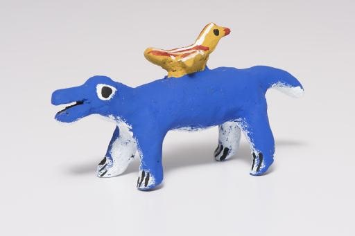 blue animal with yellow bird