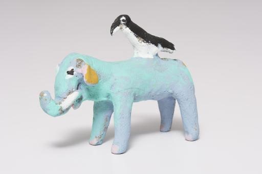 blue green elephant with black and white bird