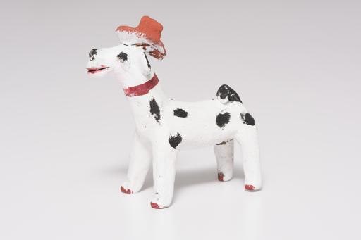 white dog with black spots and red hat