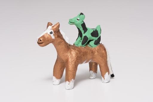 copper horse with green and black animal
