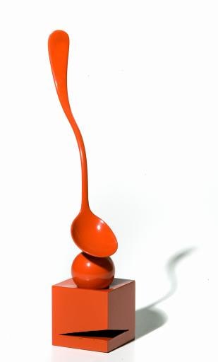 red spoon mounted on cube