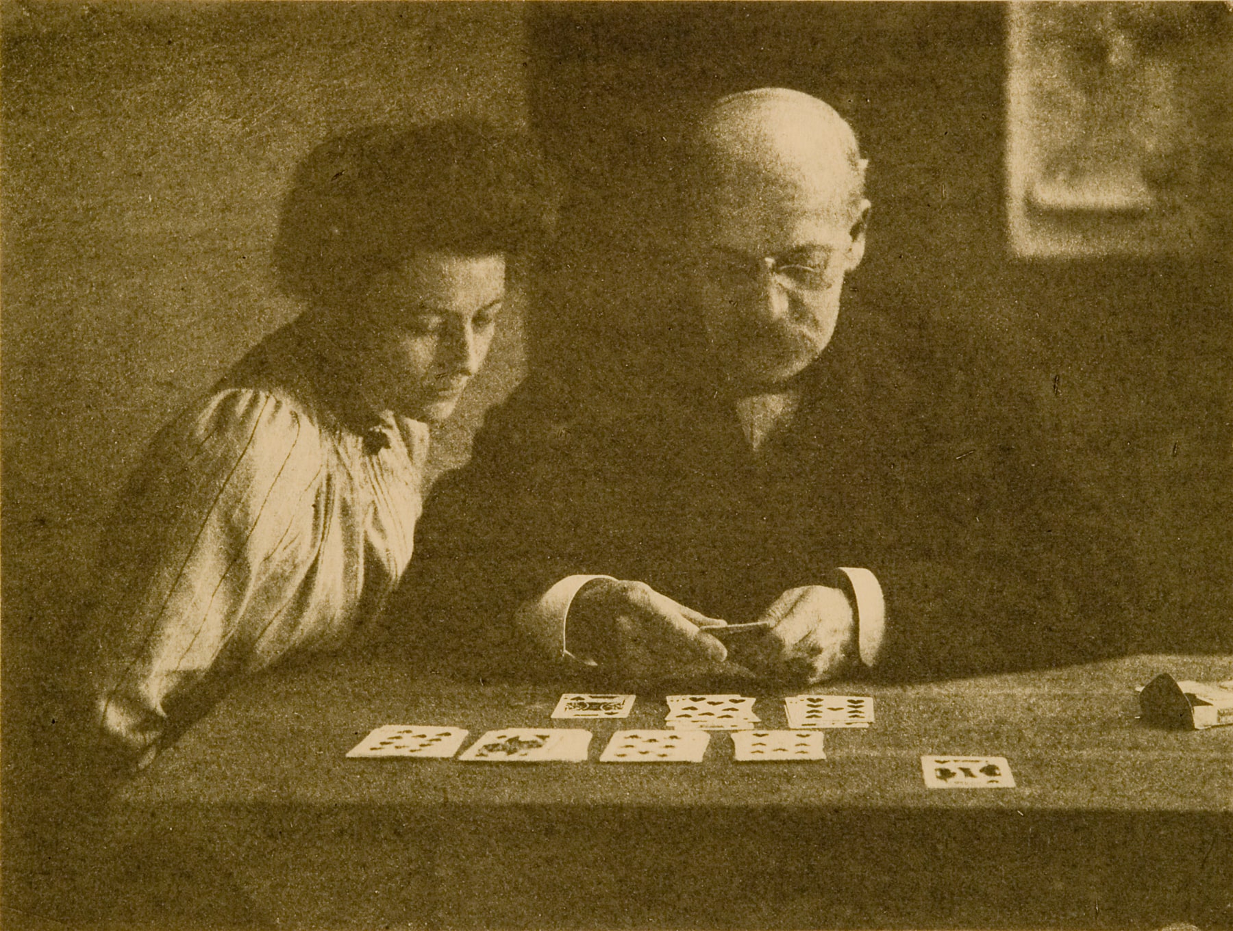 untitled (woman and man playing cards)