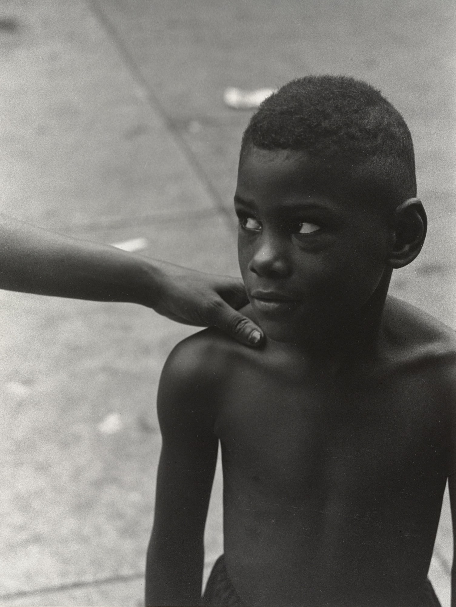 Boy, Woman's Hand on Shoulder