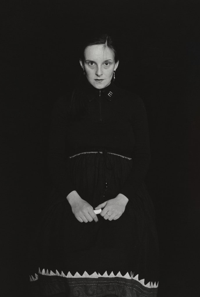 Graz. (seated in dark dress)
