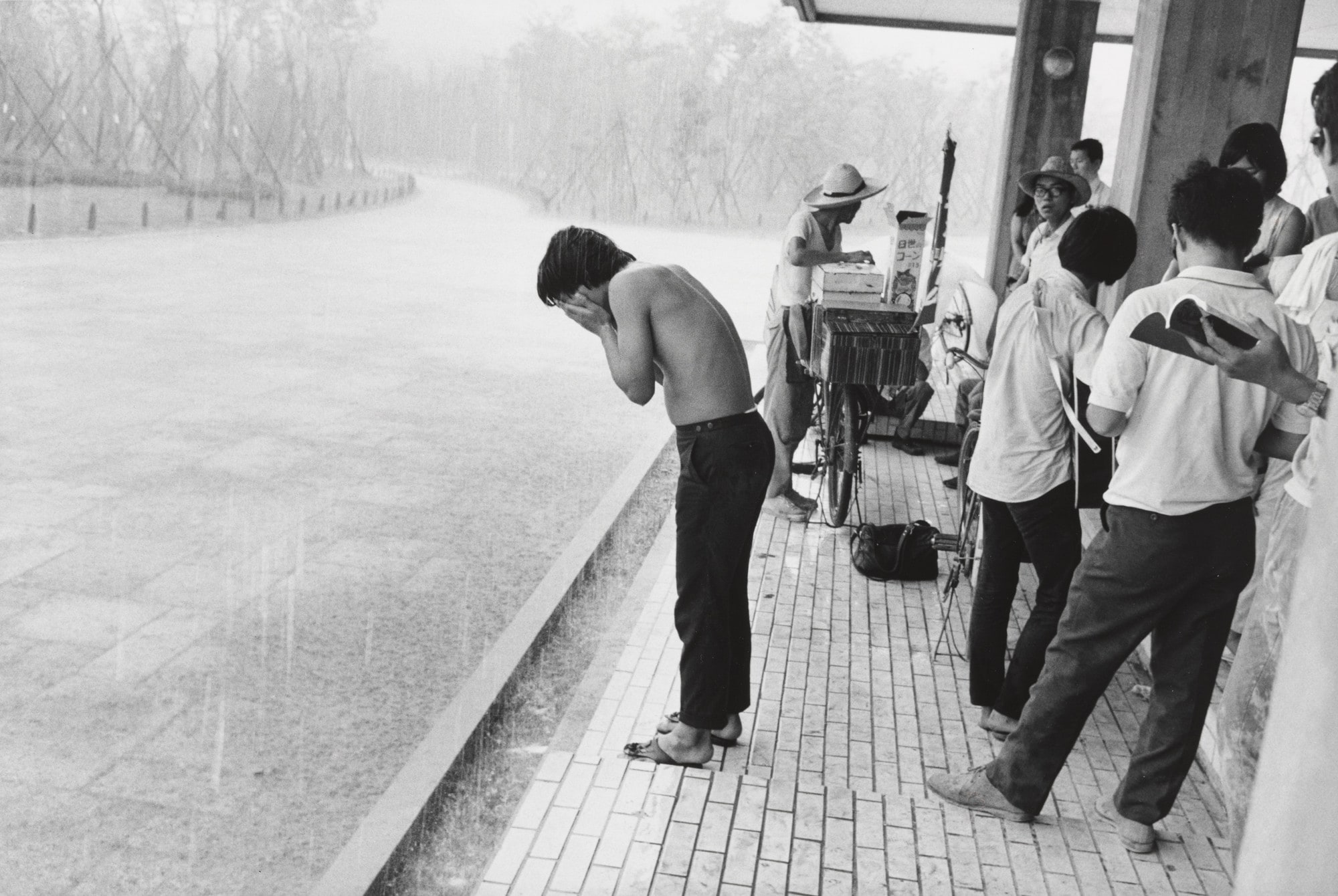 Young Man Washing His Face in the Rain at the "Anti-War Exposition", Held Near the Proposed Site for Expo '70, Osaka