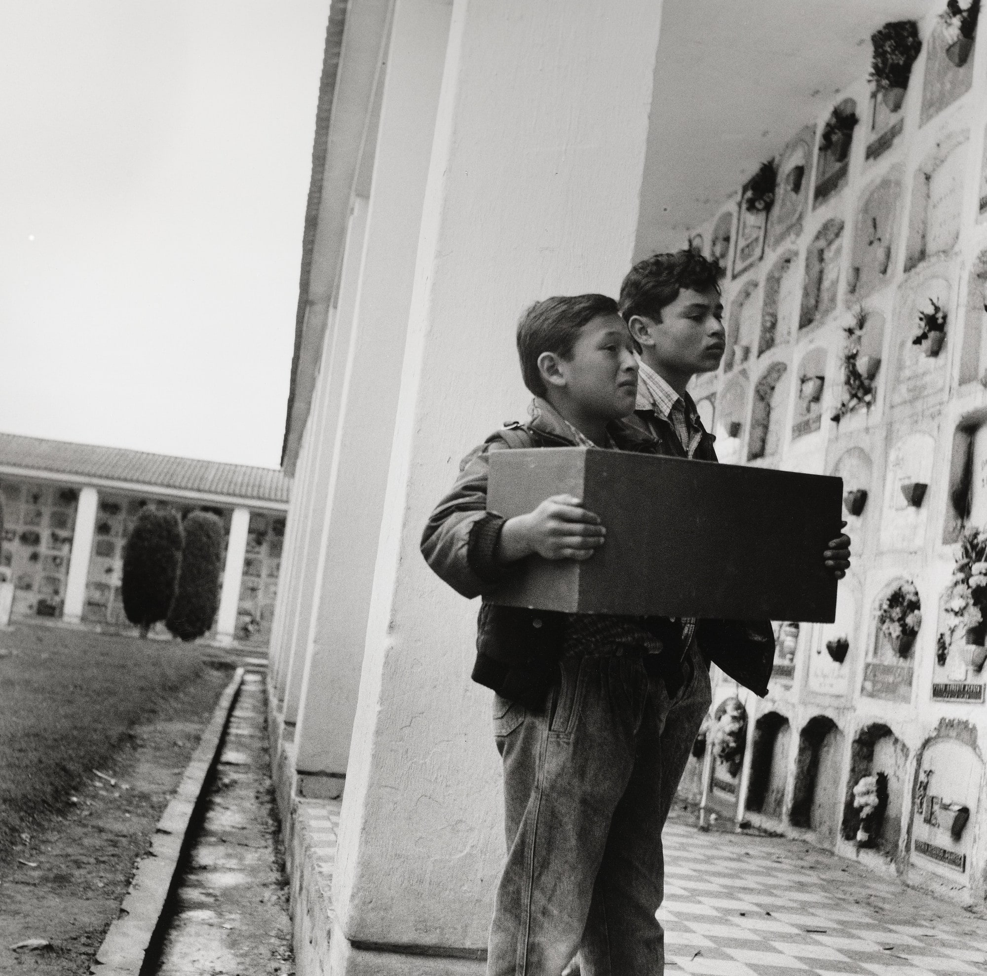 Two boys with a box of their grandmother's bones, Bogota, Colombia