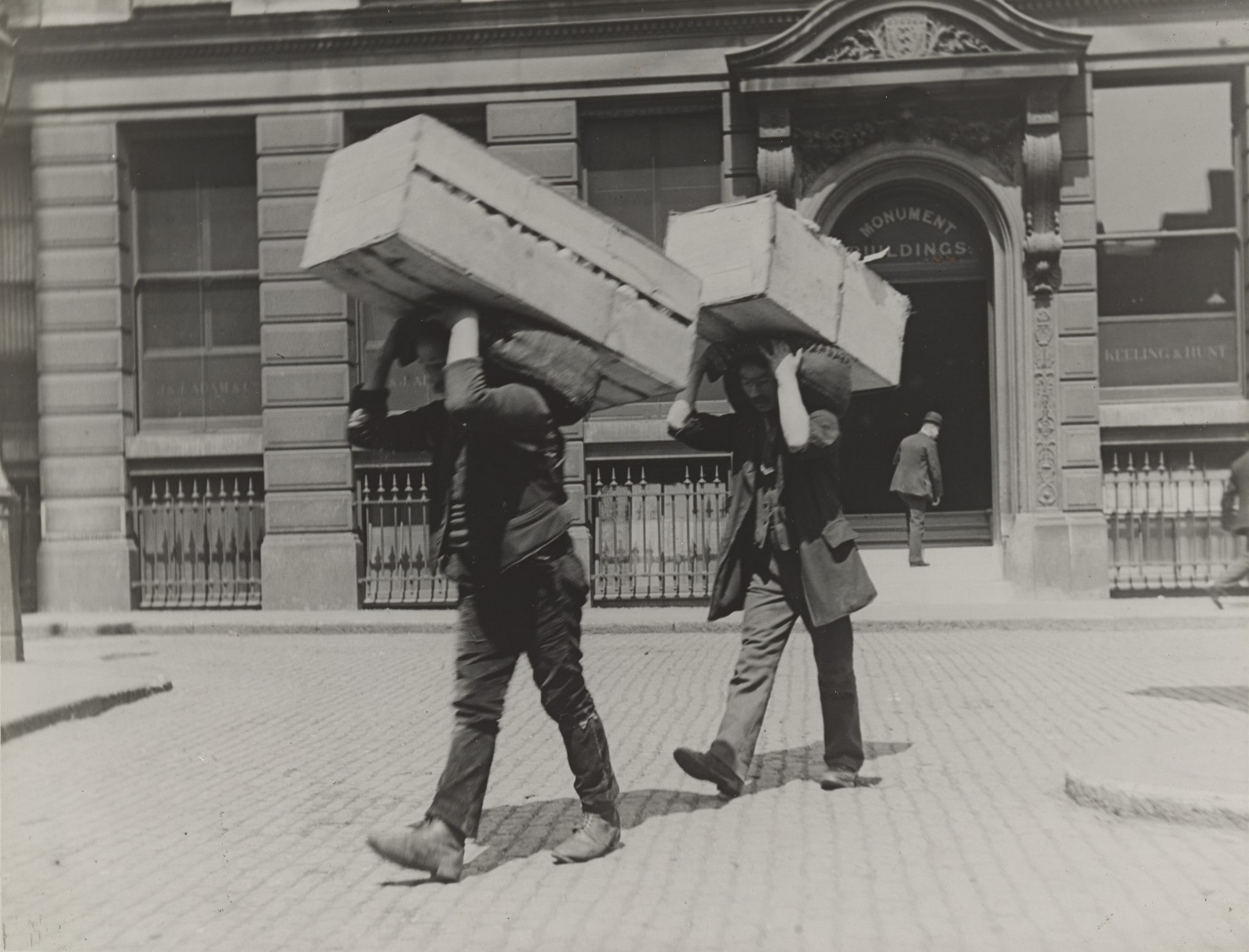 Market Porters Carrying Boxes of Oranges
