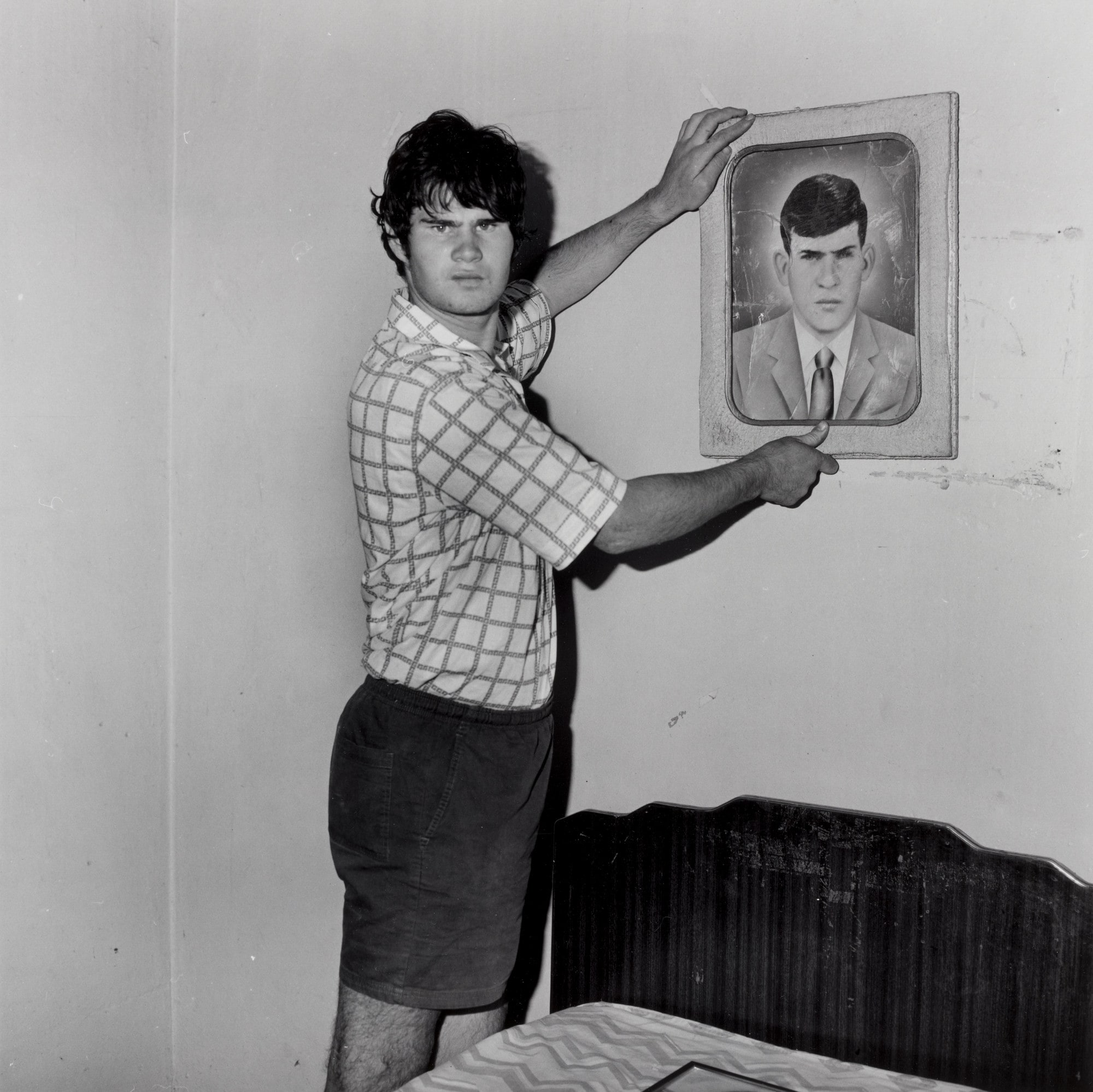 Factory Worker Holding Portrait of Grandfather