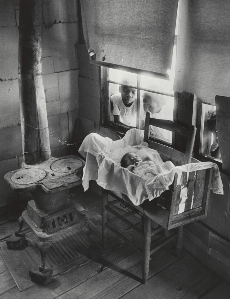 Newborn Baby in Makeshift Crib near Cold Stove