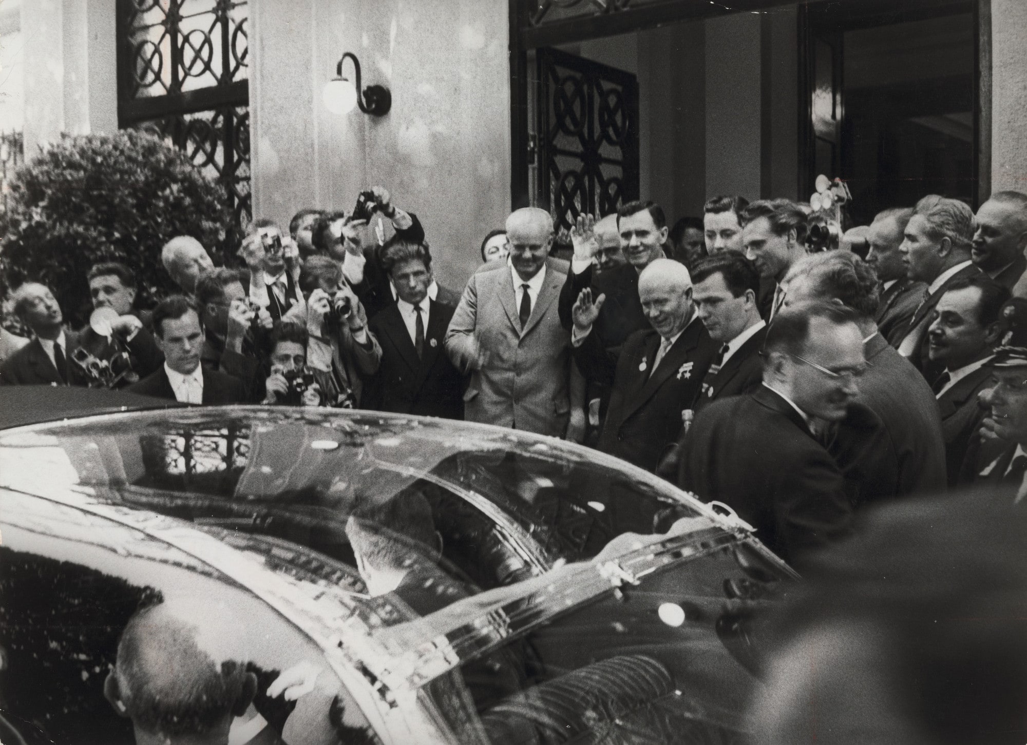 "Limousines Roll Through the Streets and Flash Bulbs Pop for the Presidents and Premiers"