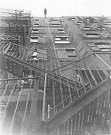 Man Walking Down the Side of a Building
